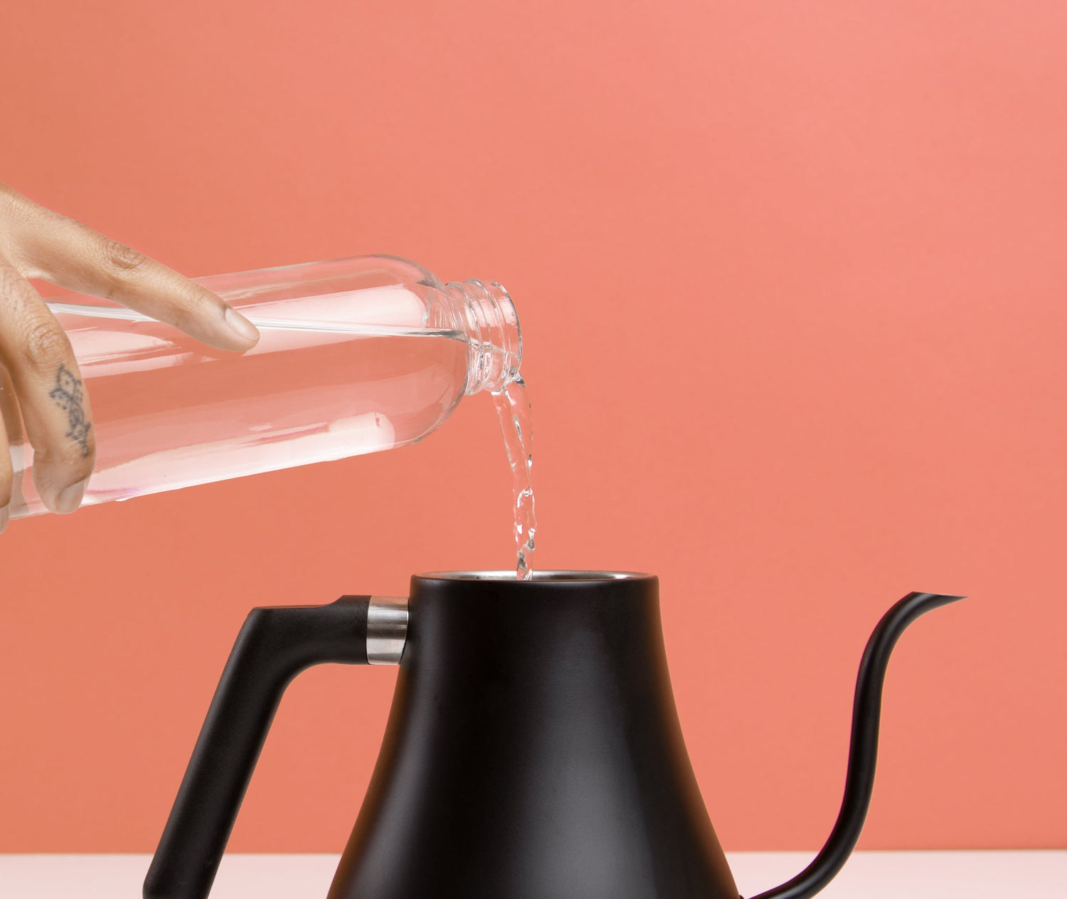 water pouring into a pour-over kettle 