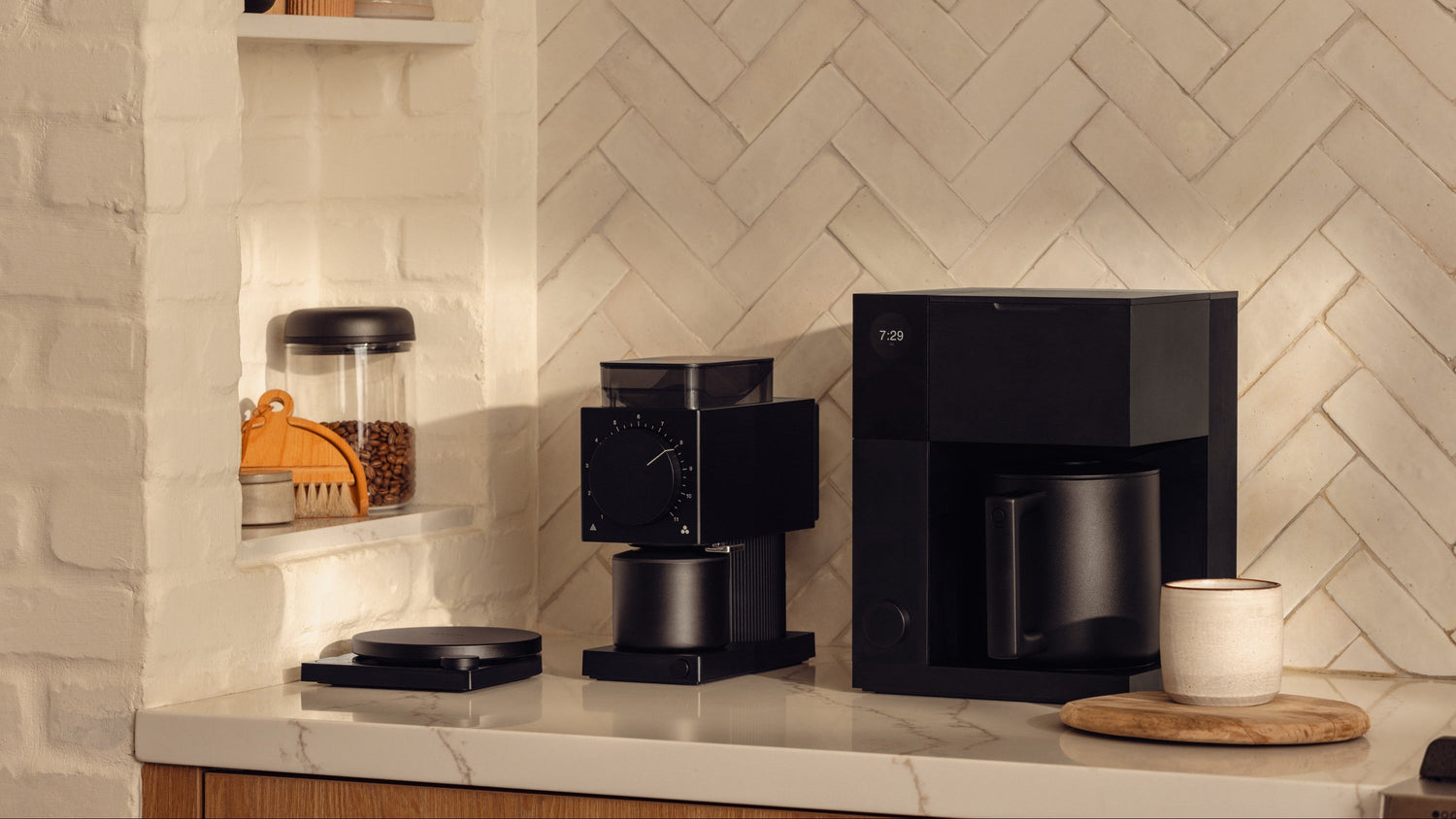 A Fellow Aiden Precision Coffee Maker and a Fellow Ode Coffee Grinder on a white counter 